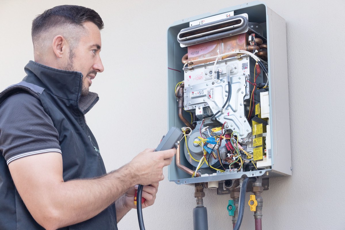 Sureflow gas fitter servicing a continuous flow hot water unit at a Hocking home