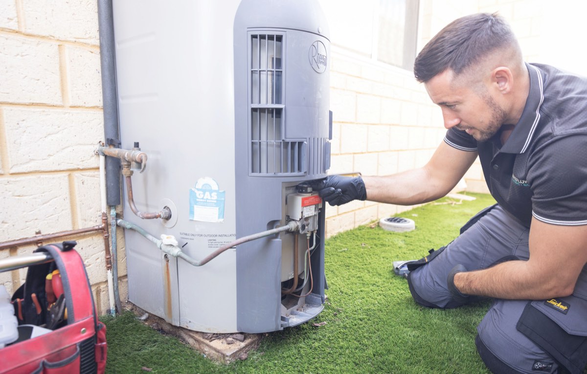 Sureflow plumber servicing a hot water unit at a newer Alkimos estate home